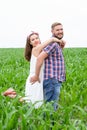 Happy loving young adult couple spending time on the field on sunny day Royalty Free Stock Photo