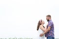 Happy loving young adult couple spending time on the field on sunny day Royalty Free Stock Photo