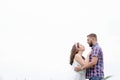 Happy loving young adult couple spending time on the field on sunny day Royalty Free Stock Photo