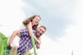 Happy loving young adult couple spending time on the field on sunny day Royalty Free Stock Photo