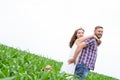 Happy loving young adult couple spending time on the field on sunny day Royalty Free Stock Photo