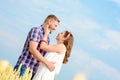 Happy loving young adult couple spending time on the field on sunny day. Royalty Free Stock Photo