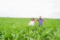 Happy loving young adult couple spending time on the field on sunny day Royalty Free Stock Photo