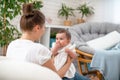 Happy loving young mother playing with her baby in the bedroom Royalty Free Stock Photo