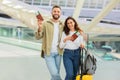 Happy Loving Young Spouses Embracing In Airport Terminal While Waiting Flight Royalty Free Stock Photo