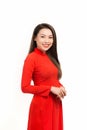 Happy lunar new year. Asian woman wearing traditional ao dai clothes portrait on white wall