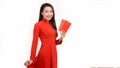 Happy Lunar new year. smile asian woman holding red envelope isolated on yellow background