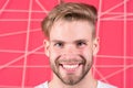 Happy macho with beard on unshaven face. Bearded man smile with blond hair and stylish haircut. Guy with healthy young skin face. Royalty Free Stock Photo