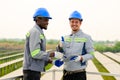 Happy maintenance engineers checking and maintaining solar panels Royalty Free Stock Photo