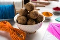 Happy Makar Sankranti Festival - Tilgul or Til ladoo in a bowl or plate with haldi kumkum and flowers with Fikri /Reel/Chakri /Spo Royalty Free Stock Photo