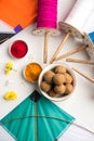 Happy Makar Sankranti Festival - Tilgul or Til ladoo in a bowl or plate with haldi kumkum and flowers with Fikri /Reel/Chakri /Spo Royalty Free Stock Photo