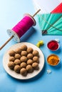 Happy Makar Sankranti - indian festival and tilgul with kite or patang and reel / fikri or spool with haldi kumkum Royalty Free Stock Photo