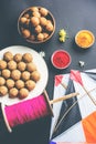 Happy Makar Sankranti - indian festival and tilgul with kite or patang and reel / fikri or spool with haldi kumkum Royalty Free Stock Photo