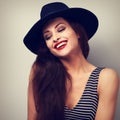 Happy makeup laughing female model in black elegant hat. Toned c
