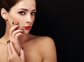 Happy makeup woman looking with red lips and black fingers on black