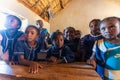 Happy Malagasy school children students in classroom. School attendance is compulsory, but many children do not go to school Royalty Free Stock Photo