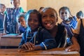 Happy Malagasy school children students in classroom. School attendance is compulsory, but many children do not go to school Royalty Free Stock Photo