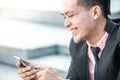 Happy Malay Businessman looking at his smartphone