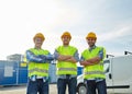 Happy male builders in high visible vests outdoors