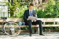 Businessman Sitting On Bench Using Laptop Royalty Free Stock Photo