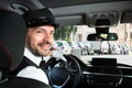 Happy male chauffeur sitting inside car Royalty Free Stock Photo