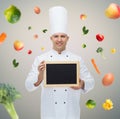 Happy male chef cook holding blank menu board Royalty Free Stock Photo