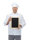 Happy male chef cook holding blank menu board Royalty Free Stock Photo