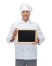 Happy male chef cook holding blank menu board Royalty Free Stock Photo