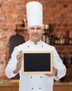 Happy male chef cook holding blank menu board Royalty Free Stock Photo