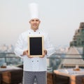 Happy male chef cook holding blank menu board Royalty Free Stock Photo