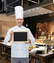 Happy male chef cook holding blank menu board Royalty Free Stock Photo