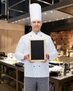 Happy male chef cook holding blank menu board Royalty Free Stock Photo