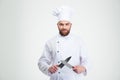 Happy male chef cook sharpening knife