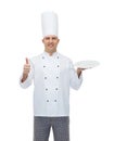 Happy male chef cook showing thumbs up and plate Royalty Free Stock Photo