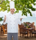 Happy male chef cook showing thumbs up and plate Royalty Free Stock Photo