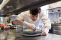 Happy male chef cooking food at restaurant kitchen Royalty Free Stock Photo