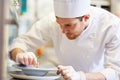 Happy male chef cooking food at restaurant kitchen Royalty Free Stock Photo