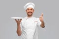 happy male chef with empty plate showing thumbs up Royalty Free Stock Photo