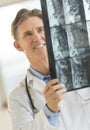 Happy Male Doctor Analyzing X-Ray Image