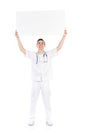 Happy male doctor holding empty placard over his head Royalty Free Stock Photo