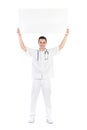 Happy male doctor showing empty placard over his h Royalty Free Stock Photo