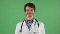 Happy male doctor smiling to the camera on chromakey Royalty Free Stock Photo