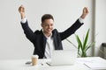 Happy male employee celebrating good online result looking at la Royalty Free Stock Photo