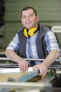 happy male engineer working on machine in factory Royalty Free Stock Photo