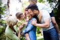 Happy male and female playing and enjoying picnic with children outside Royalty Free Stock Photo