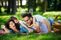 Happy male and female playing and enjoying picnic with children outside Royalty Free Stock Photo