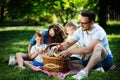 Happy male and female playing and enjoying picnic with children outside Royalty Free Stock Photo