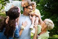 Happy male and female playing and enjoying picnic with children outside Royalty Free Stock Photo