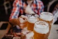 People, men, leisure, friendship and celebration concept - happy male friends drinking beer and clinking glasses at bar or pub Royalty Free Stock Photo