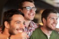 Happy male friends watching football at bar or pub Royalty Free Stock Photo